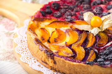 Berry pie, a tart filled with jam made from black currants, in glass form a gray background. Selective focus, close-up.