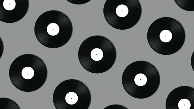 Geometric pattern with retro vinyl disks on a gray background. Minimal motion graphics music animation concept