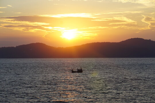 Silhouette of boat on sea during sunset