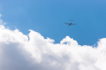 Fototapeta na wymiar A large plane flies into the clouds