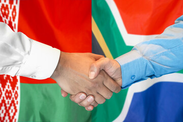 Business handshake on the background of two flags. Men handshake on the background of the Belarus and South Africa flag. Support concept