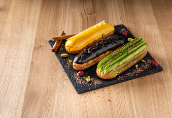 Three colorful tasty cakes on slate plate