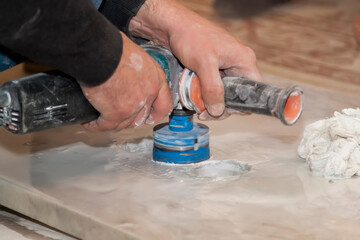 handyman cut round holes for electrical outlets in marble countertop for kitchen using electirc...