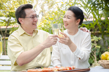 senior people celebrating with White wine and barbecure
