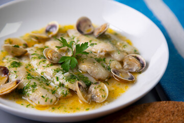 Fish with clams cooked al pil pil, traditional recipe from Bilbao, north spain.