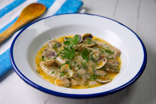 Fish with clams cooked al pil pil, traditional recipe from Bilbao, north spain.
