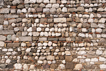 old external wall of the house made with stones, stone block and some bricks. old wall background