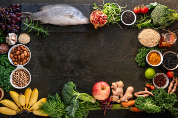 Obraz na płótnie Canvas Healthy food clean eating selection: fish,fruit, vegetable, seeds, superfood, cereals, leaf vegetable on old kitchen table background copy space. Healthy food for humans. Background with for text