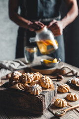 Man pours Hot tea with slices of fresh grapefruit on wooden tablet. Healthy drink, Eco, vegan.