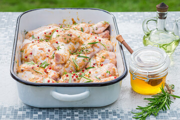 Seasoning chicken legs for grill with honey and rosemary