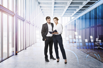 Man and woman in panoramic office with graphs