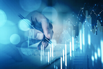 Businessman hand drawing virtual chart or collect stock market rates into notebook to make a forecast. Double exposure. The concept of successful investment decision