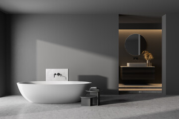Naklejka na ściany i meble Modern bathroom interior with dark concrete walls, gray floor, white bathtub and sink. 3d rendering