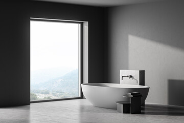 Fototapeta na wymiar Modern bathroom interior with dark concrete walls, gray floor, white bathtub. Panoramic window. 3d rendering