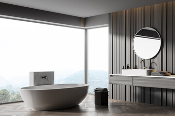 Interior of modern corner bathroom with dark brown walls, wooden floor, white bathtub and double sink with round mirror. Countryside view from window. 3d rendering