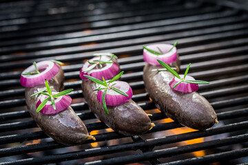 Grilling black pudding with onion in summer