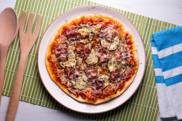 Pizza with vegetables and bacon, traditional italian recipe