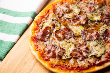Pizza with vegetables and bacon, traditional italian recipe