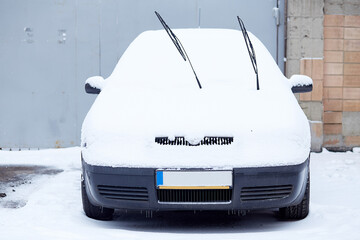 Car covered with fresh winter snow