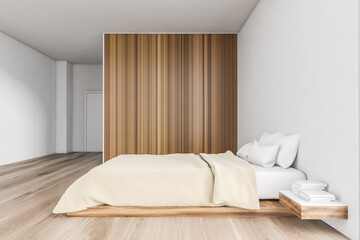 Beige bedroom, bed with linens and wooden wardrobe on parquet floor