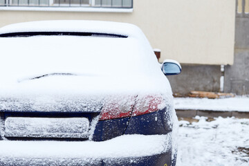 Window of car parked on the street in winter day, rear view. Mock-up for sticker or decals