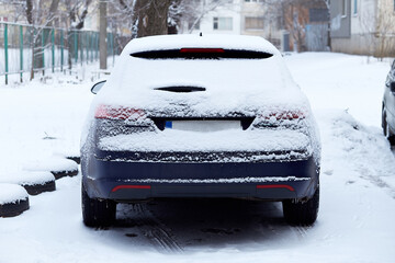 Window of car parked on the street in winter day, rear view. Mock-up for sticker or decals