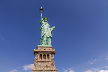 Fototapeta na wymiar The Statue of Liberty on blue sky background under the sunshine