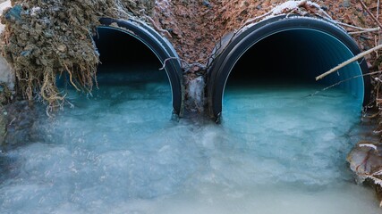 Frozen stream under a road