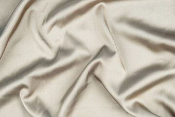 wavy rippled beige silk satin fabric background