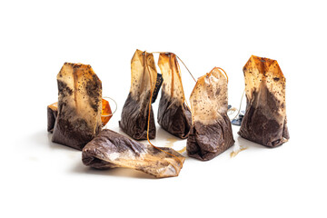 Several used tea bags on a white background