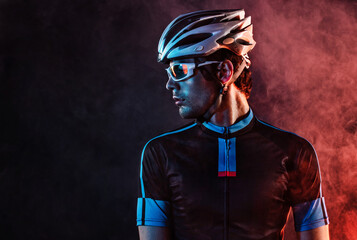 Spost background with copyspace. Cyclist. Dramatic colorful close-up portrait. - obrazy, fototapety, plakaty