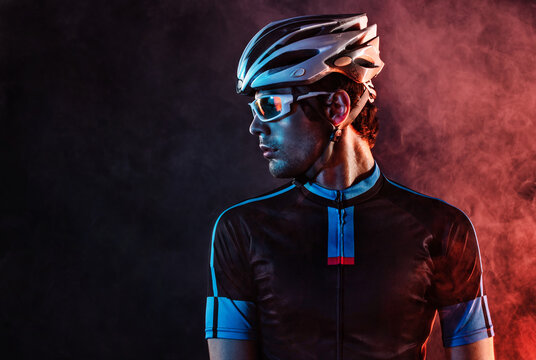 Spost background with copyspace. Cyclist. Dramatic colorful close-up portrait.