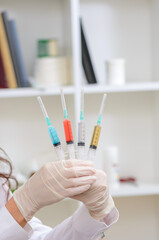 colorful medical syringes in the hands of a nurse