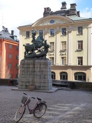 Old bicycle near the monument.  Walk through the streets of the old town of Stockholm, Sweden. Scandinavian travel. Euro-trip. 