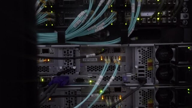 Network Provider cables installed in the rack at data center. Fiber optic in server room.