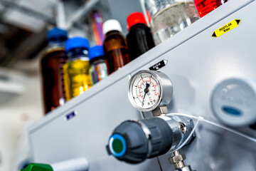 Closeup of pressure manometer measuring gas pressure, industry background, selective focus, pipes...