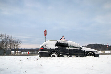 Abandoned car in the ditch after the traffic accident. The driver didn&acute;t give way to another car. Covered by snow. 