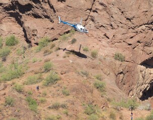View of a hiker being airlifted from a dangerous situation on Camelback Mountain using a Phoenix...