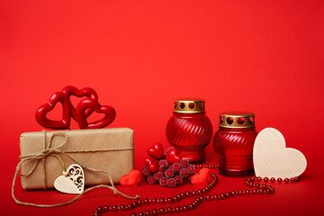  Box in craft paper with a heart made of red threads, decorative red fruits on a red background