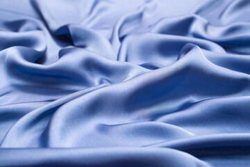 Blue silk or satin luxury fabric texture. Top view.