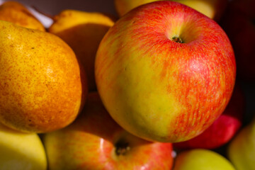 Several red-green apples standing on top of each other