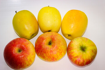 Several apples standing on a white background