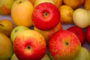 Several red-green apples standing on top of each other