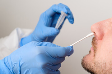 Coronavirus test. Medical worker or nurse taking a nasal swab for coronavirus sample from patient