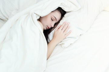 Lifestyle portrait of cute girl sleeping on bed