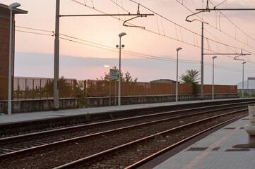 Fototapeta na wymiar Railroad at sunset. Section of railway along the Cilento coast, Italy.