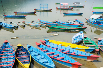 Fototapeta na wymiar Colorful wooden boats in Phewa Lake, Pokhara, Nepal