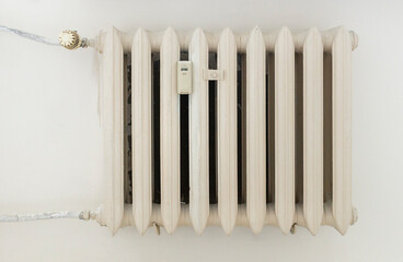 White steel rib radiator in a new bright renovated room in apartment or home 
