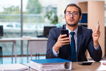 Young male employee working in the office