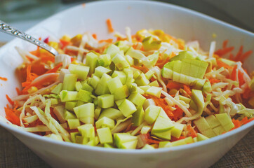 Fresh salad from fresh vegetables and fruits, close-up. Healthy food.